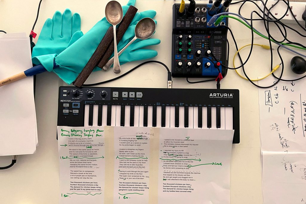 desk with musical equipment, rubber gloves and script
