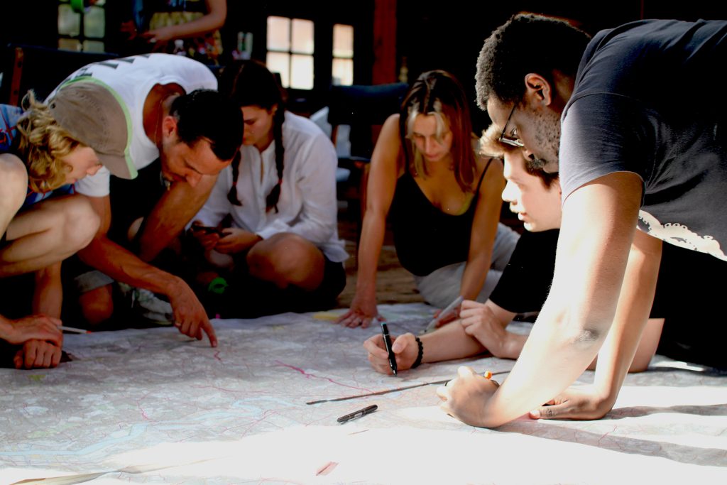 People around table making drawings